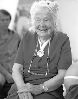 Ida Rolf – twórczyni Integracji Strukturalnej – na zdjęciu w podeszłym wieku, uśmiechnięta, w otoczeniu ludzi.